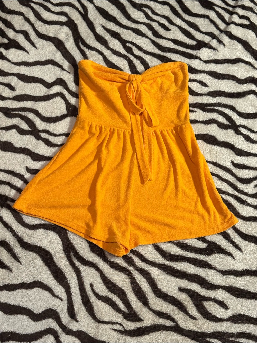 Strapless Romper in Highlighter Orange.